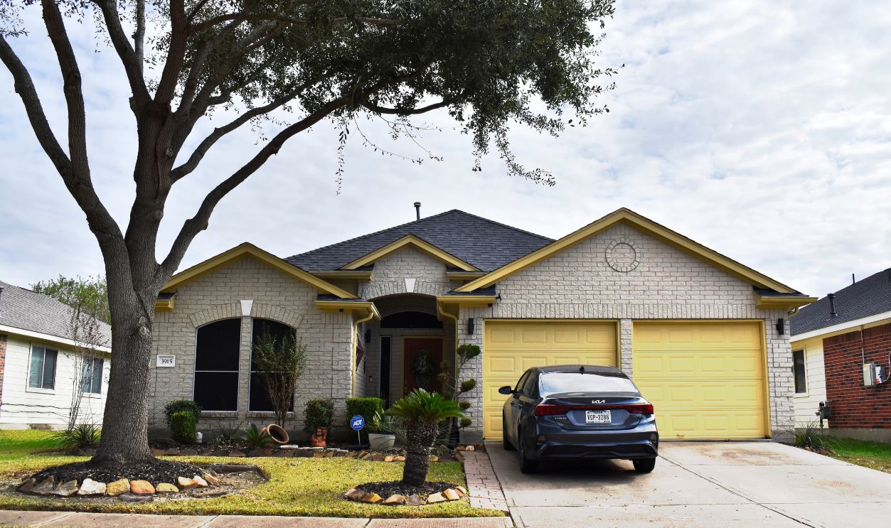 Houston, TX USA November 27, 2025 - A beautiful portrait of a retro-styled home and a Hyundai Elantra sedan in the heart of Houston Texas. This image is color enhanced.