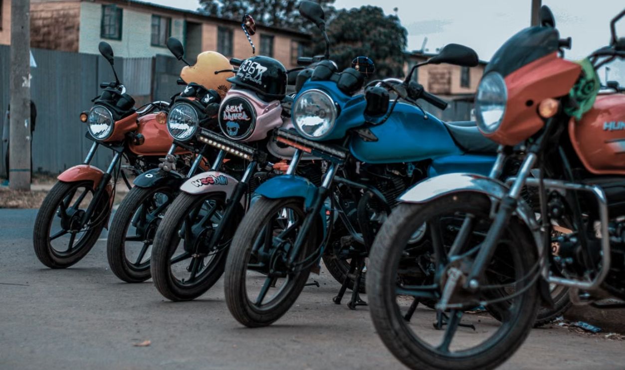 Vibrant motorcycles lined up along a city street, showcasing urban life.