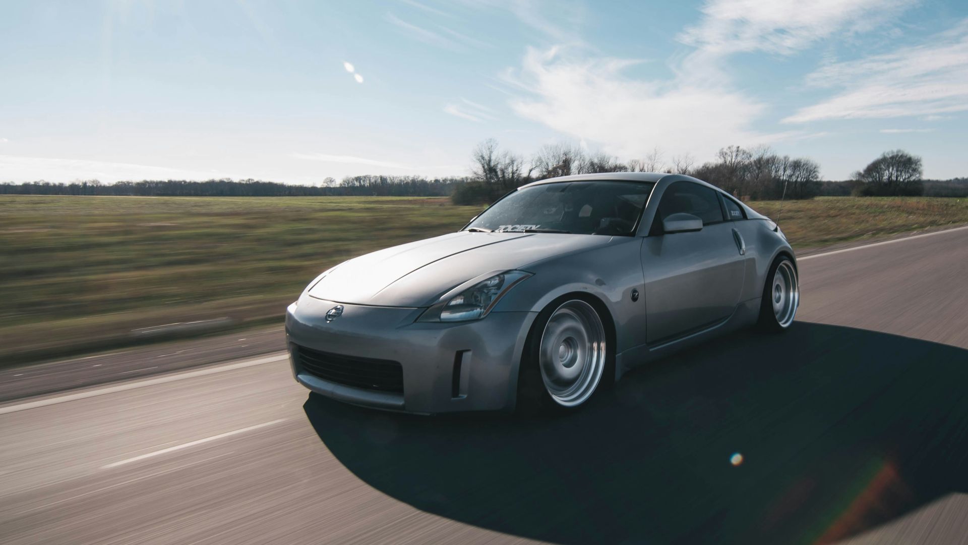 photo of gray coupe on road at daytime