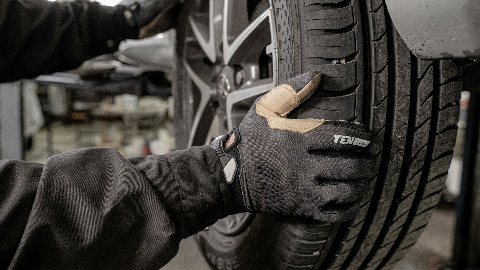 a man working on a tire in a garage