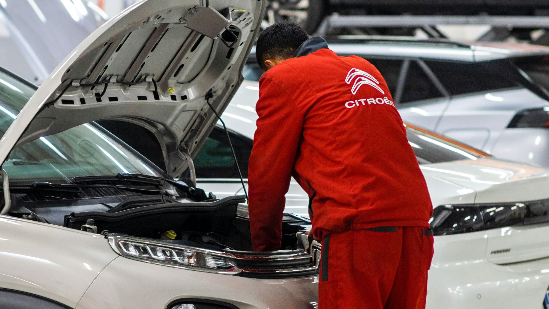 A man working on a car in a garage