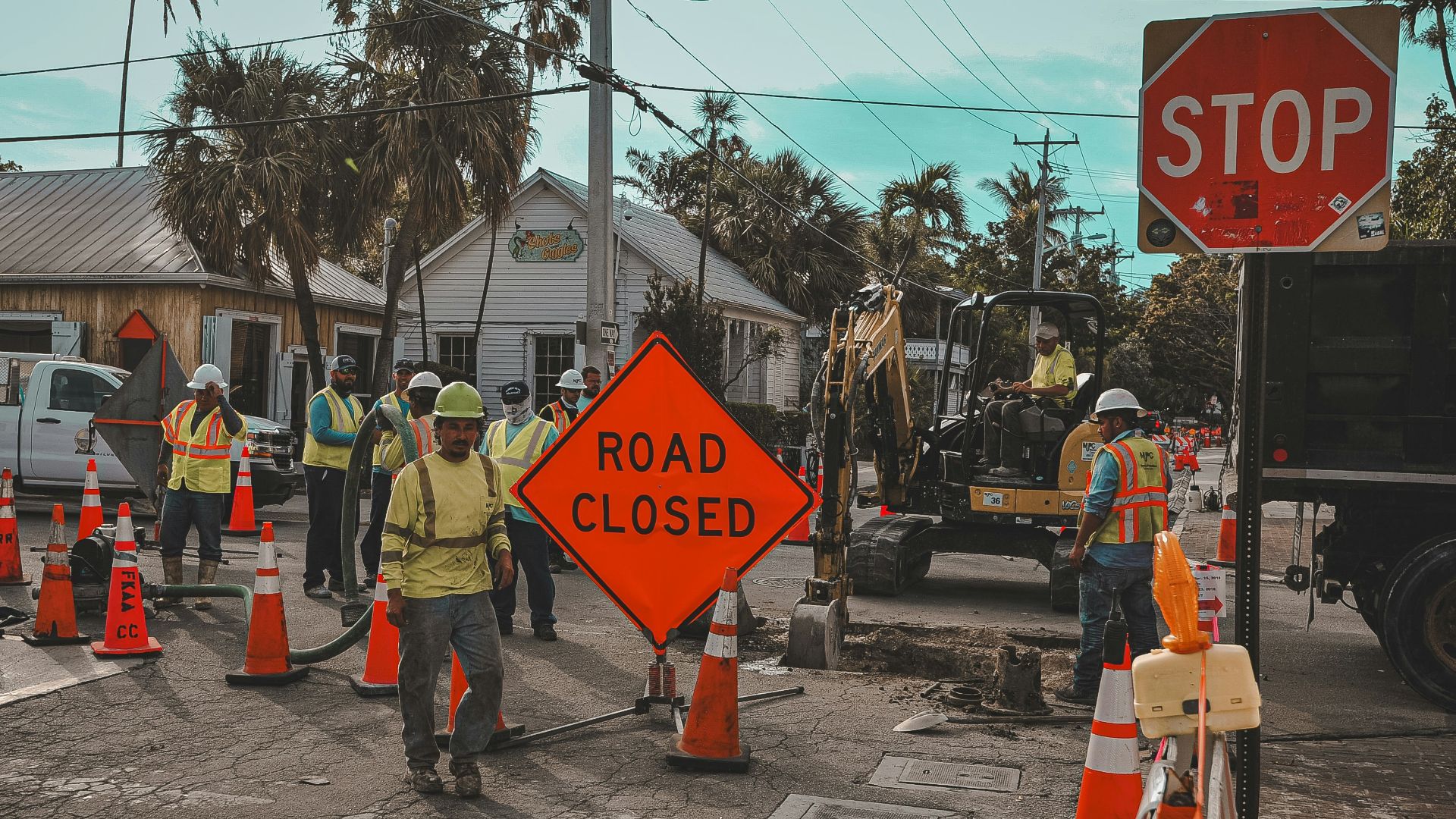 Construction workers and road closed signs on a street