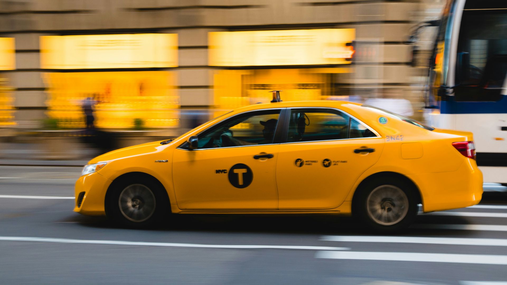 tilt shift photography of yellow taxi car