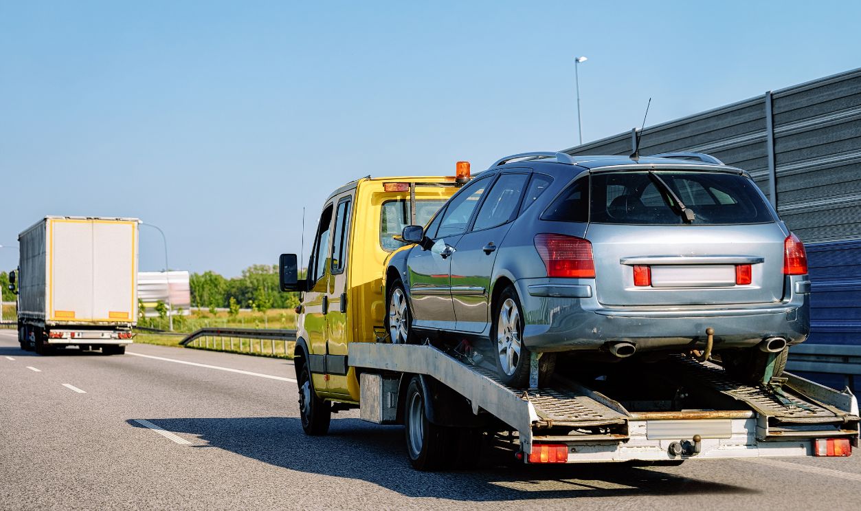 Tow truck transporter carrying car on the Road in Slovenia.