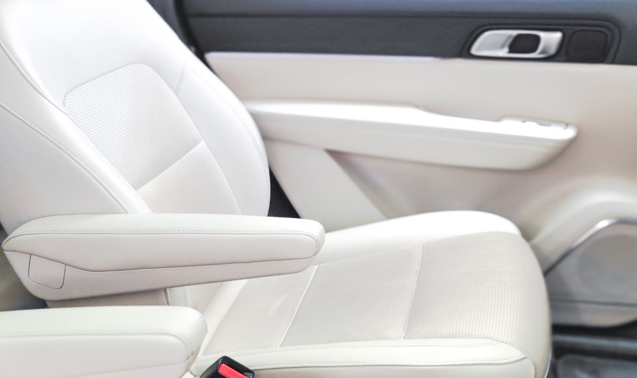 Closeup unmanned white leather car seat