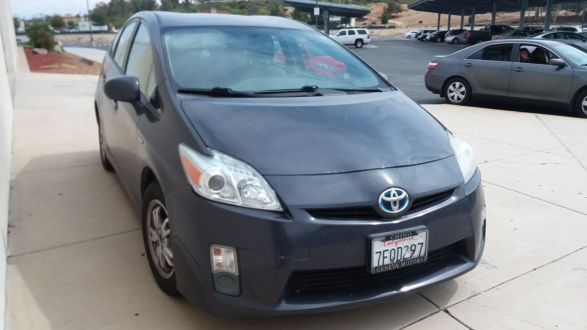This is a Gray Toyota Prius (XW30) hybrid front view.