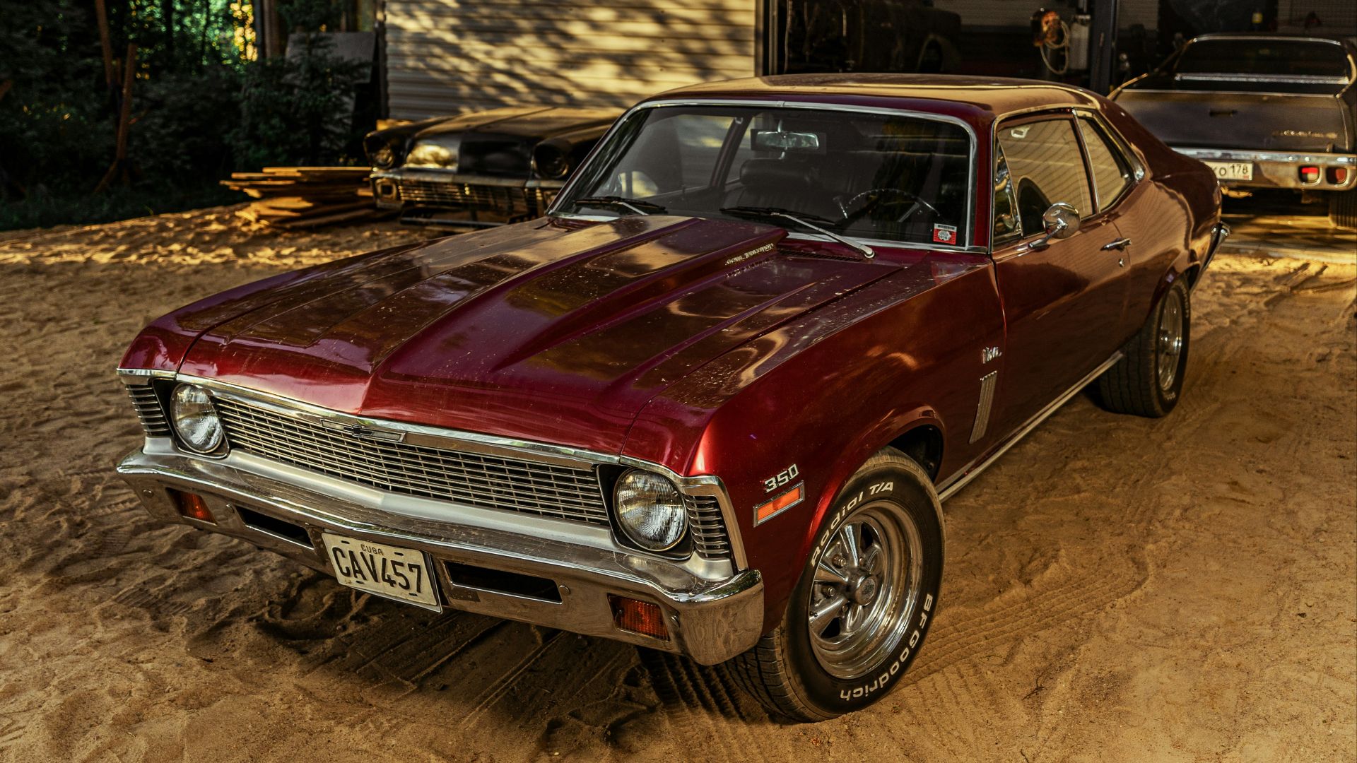 red chevrolet camaro parked in garage