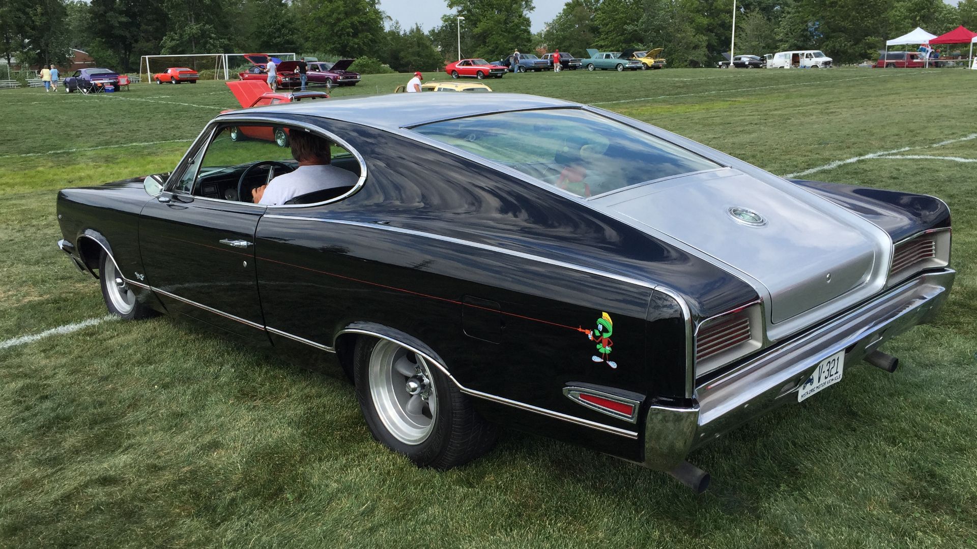 1967 AMC Marlin fastback, a full-sized personal luxury car built by American Motors Corporation. Finished in two-tone black and silver, this car has aftermarket wheels, custom pin striping, as well as the hood and cowl panel from a 1968 Ambassador that ha