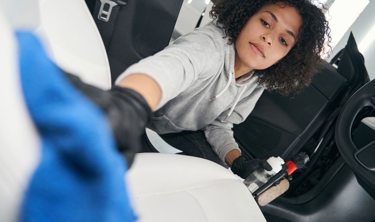 Concentrated detailer toweling down automotive leather upholstery