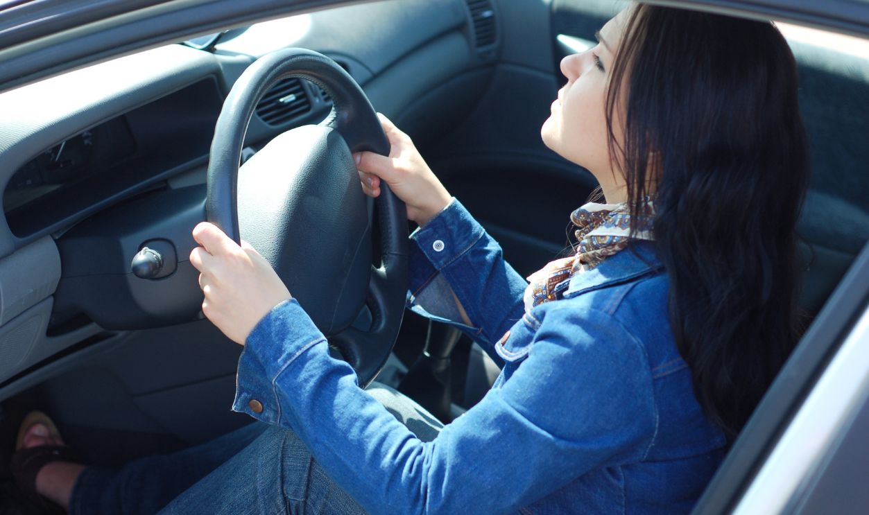 happy woman in new car