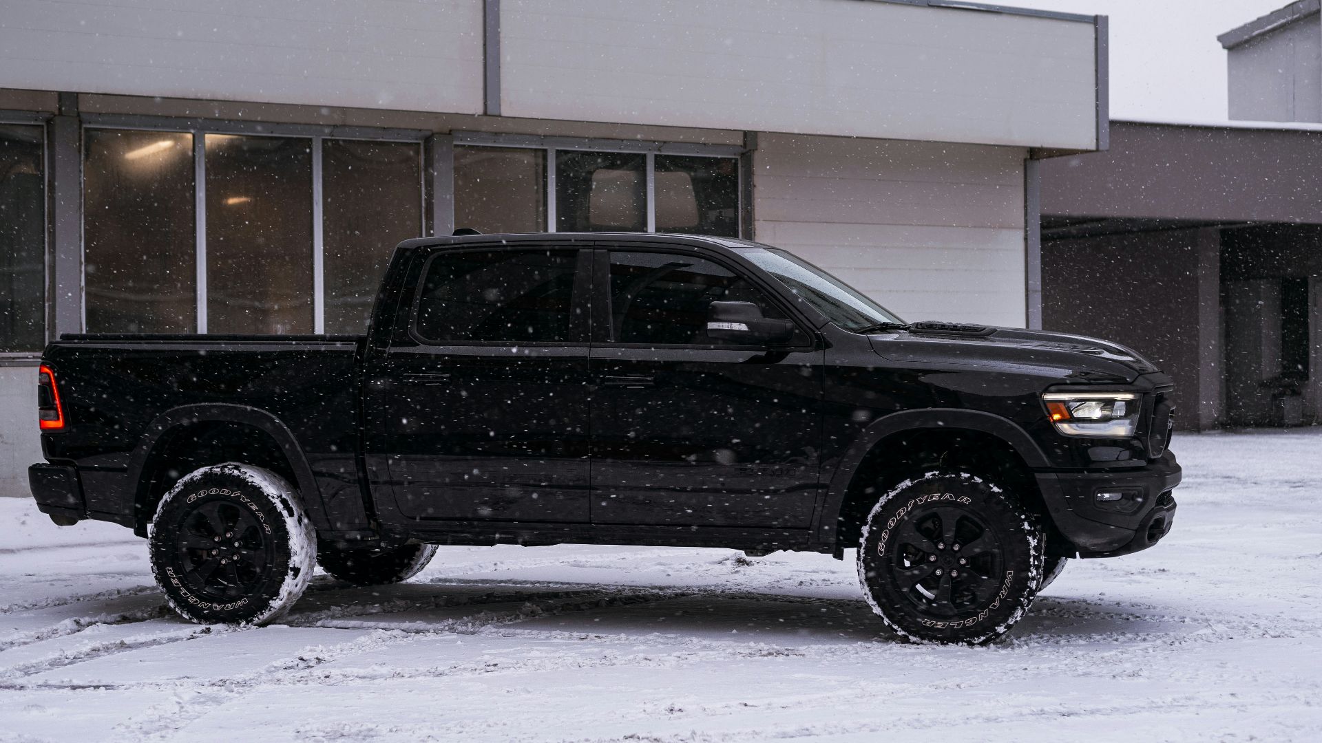 a black truck parked in front of a building