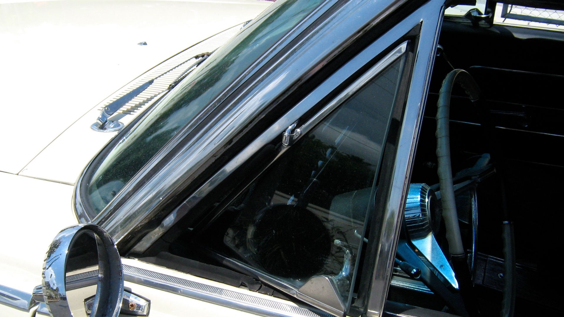 American Motors (AMC) 1965 Rambler 990 Ambassador convertible. Detail of driver's side vent window and the factory (remote adjustable) outside rear view mirror.