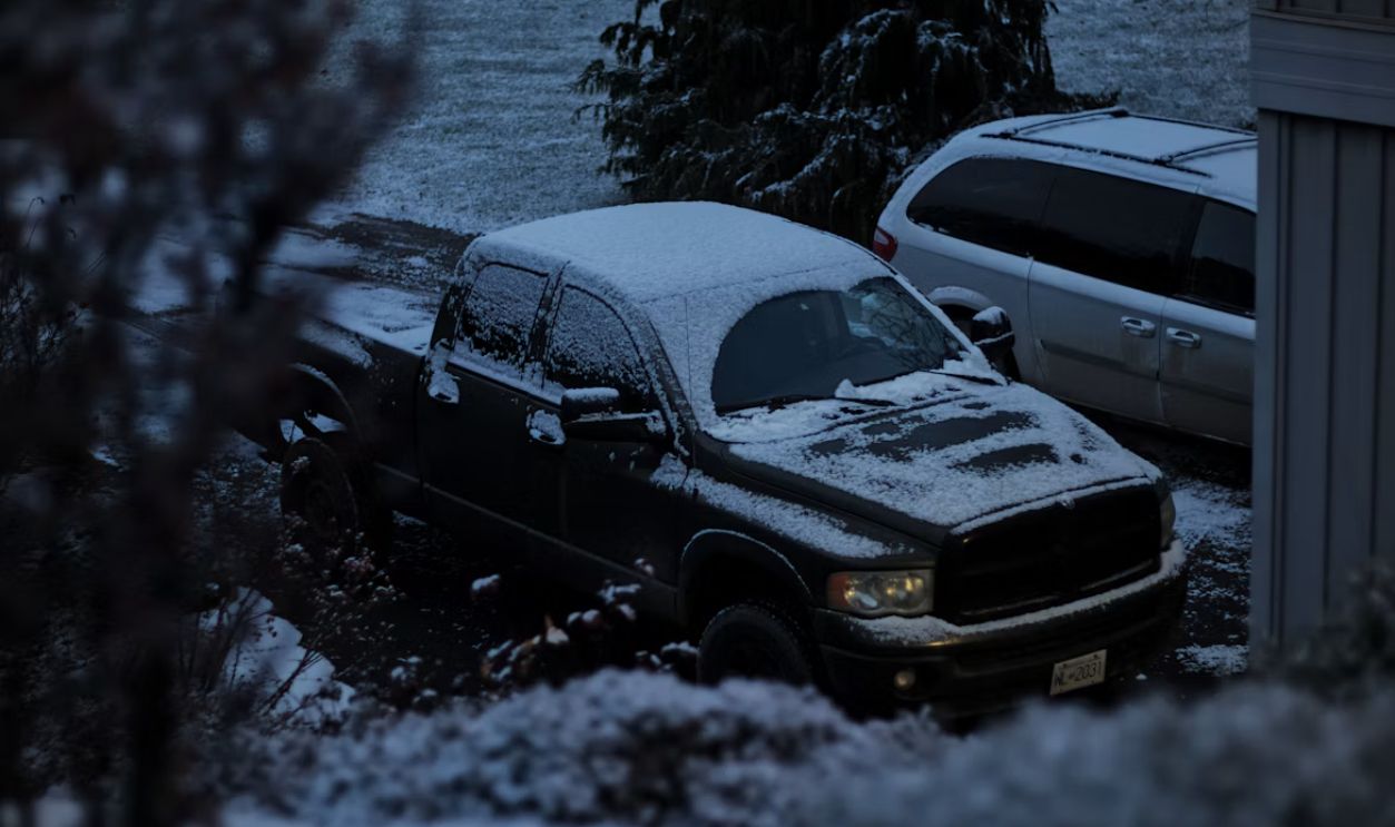 A couple of trucks that are parked in the snow