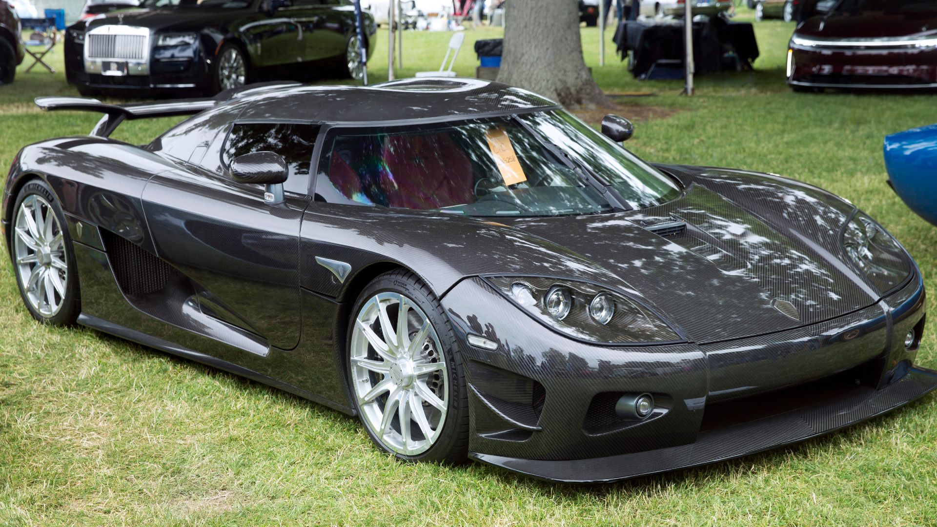 A 2008 Koenigsegg CCX Edition in polished carbon fiber, seen at the 2023 Greenwich Concours d'Elegance. The CCX Edition was more track oriented than the standard CCX; this is example #1 of two built. It was built to celebrate the tenth anniversary of the 