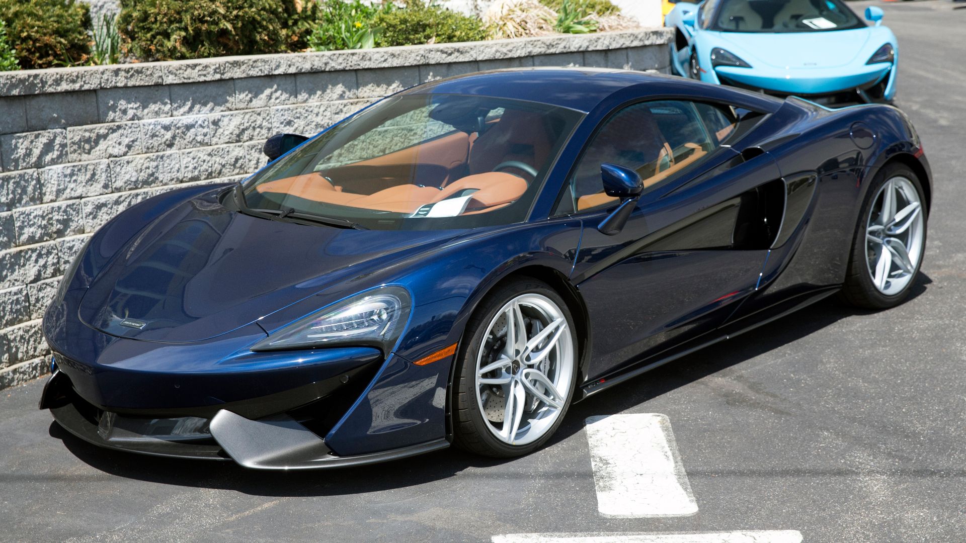 A 2017 McLaren 570S at a dealership in Long Island, NY. Blue with Saddle Tan interior, 7-speed dual-clutch transmission, etc etc. And Carbon Fiber Switch Packs, whatever those may be.