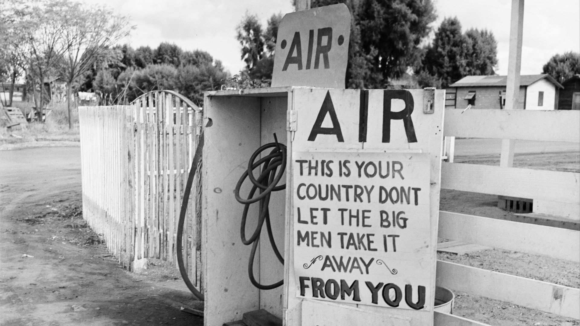 Gas station, Kern County, California. Sign during great cotton strike. Photo shows an Air pump, with a hand-lettered sign: “This is your country -  don't let the big men take it away from you.”