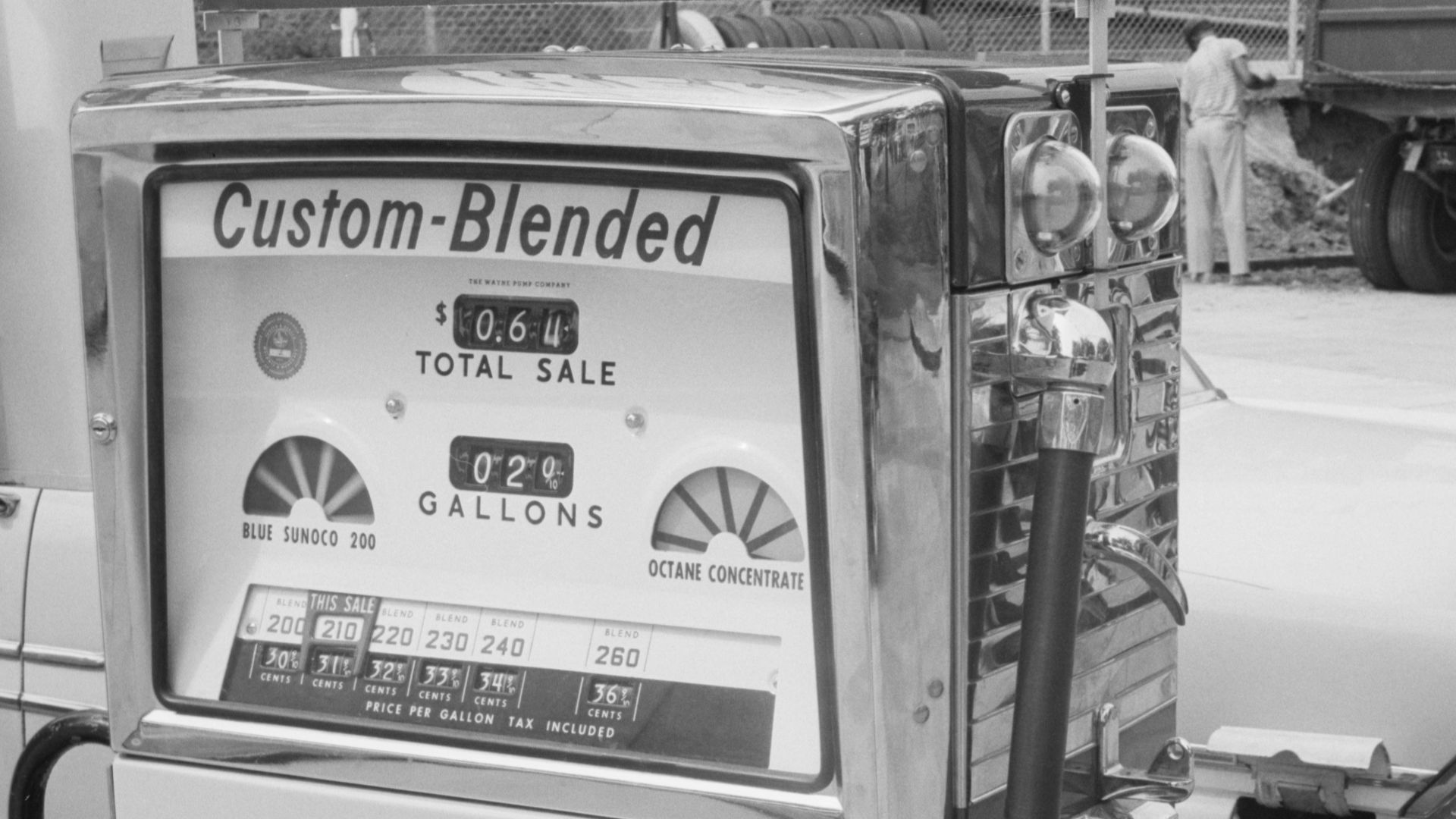 Gas station attendant filling a car tank with custom blend gas, at a Sunoco gas station, Washington, D.C. area