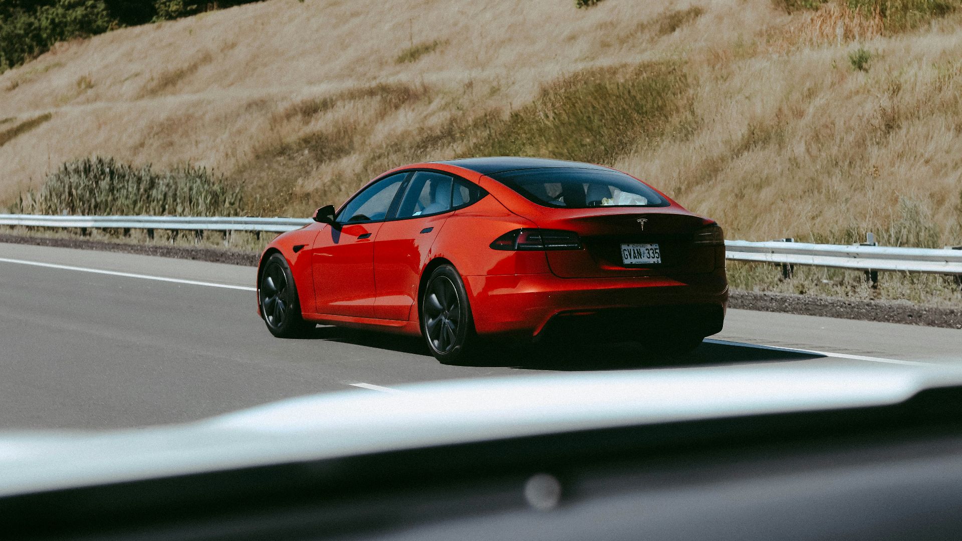 a red sports car on a road