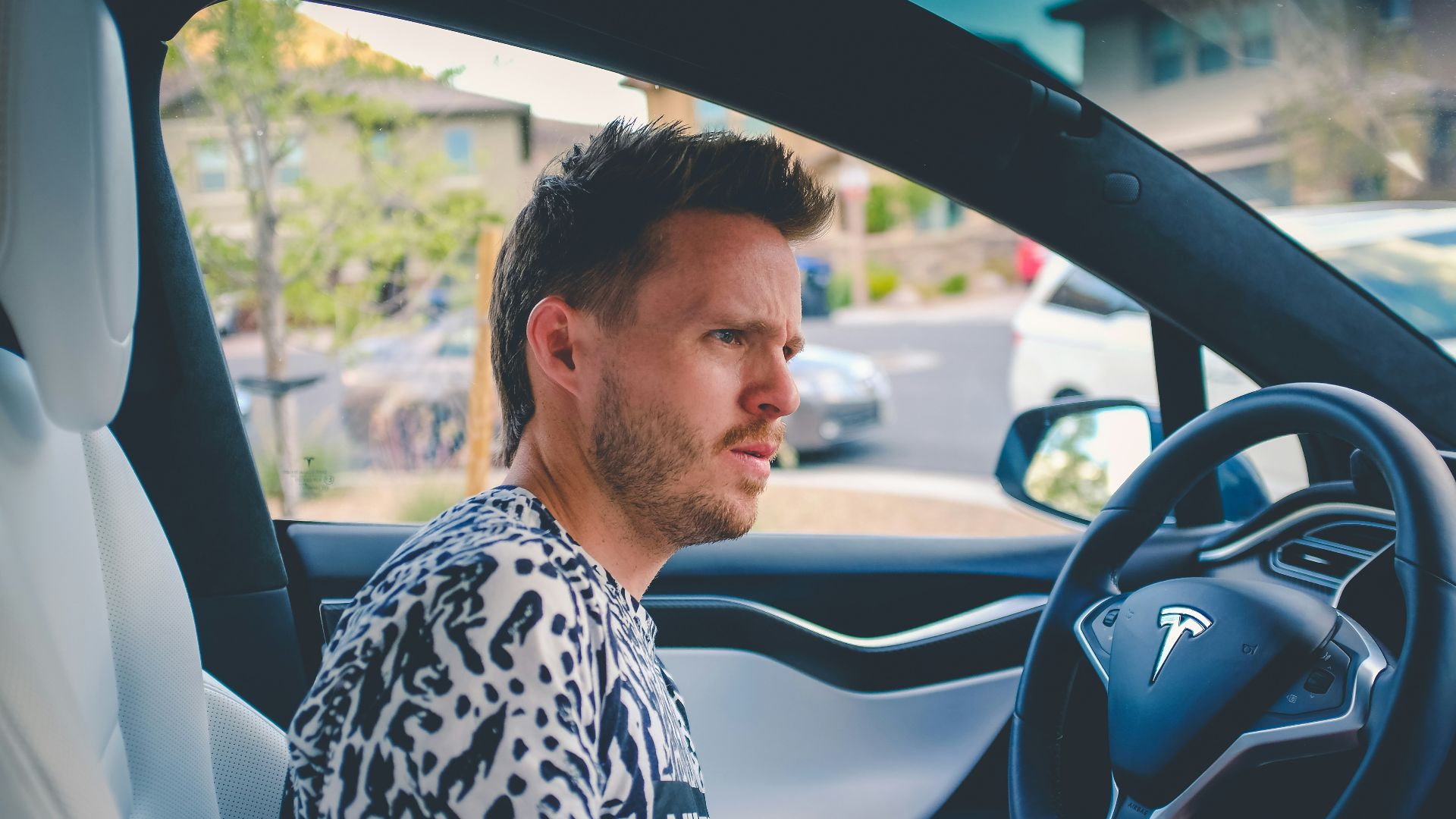 man sitting on car front seat
