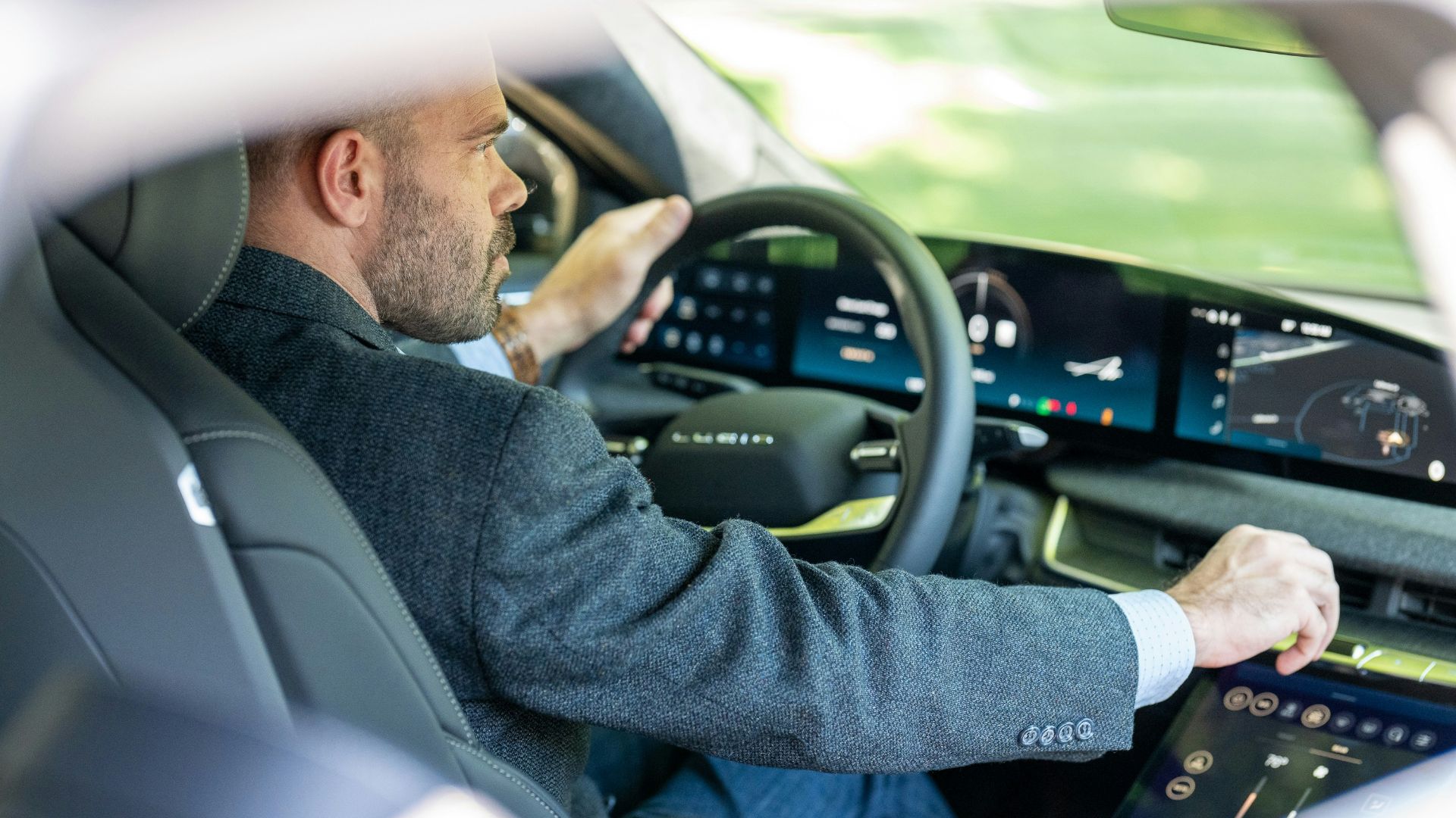 a man in a suit driving a car