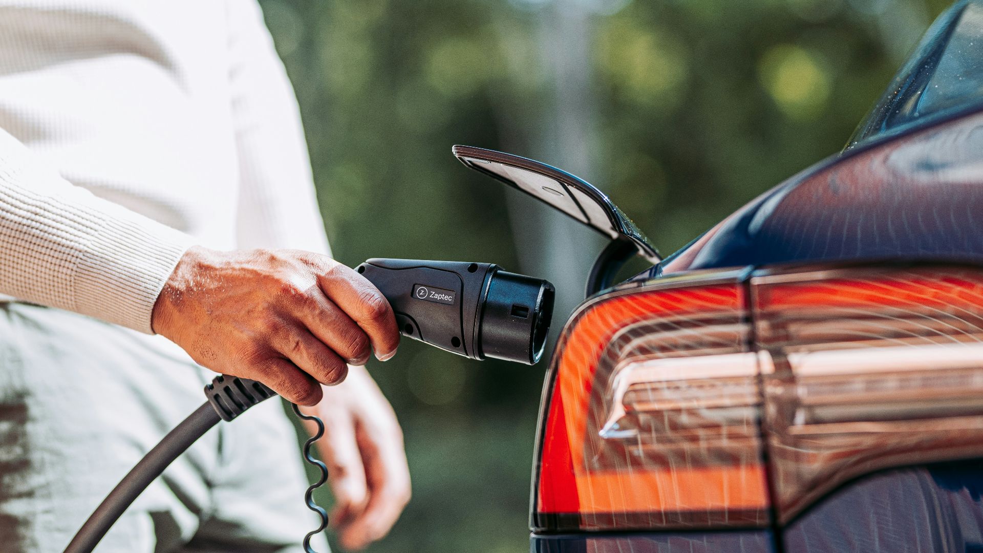 A man pumping gas into his car at a gas station