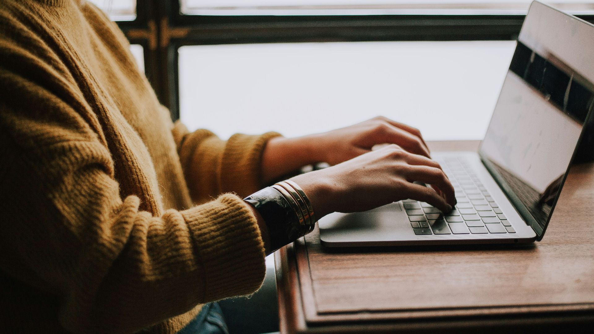 person sitting front of laptop