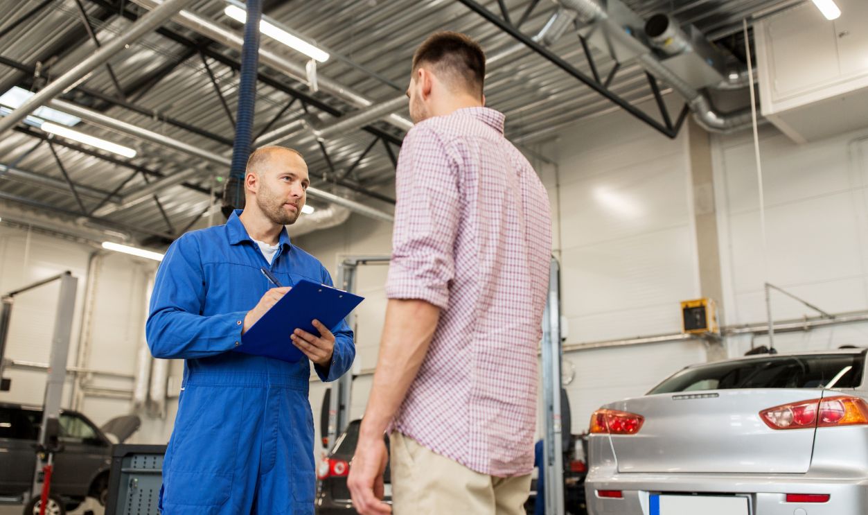 man talking with car mechanic