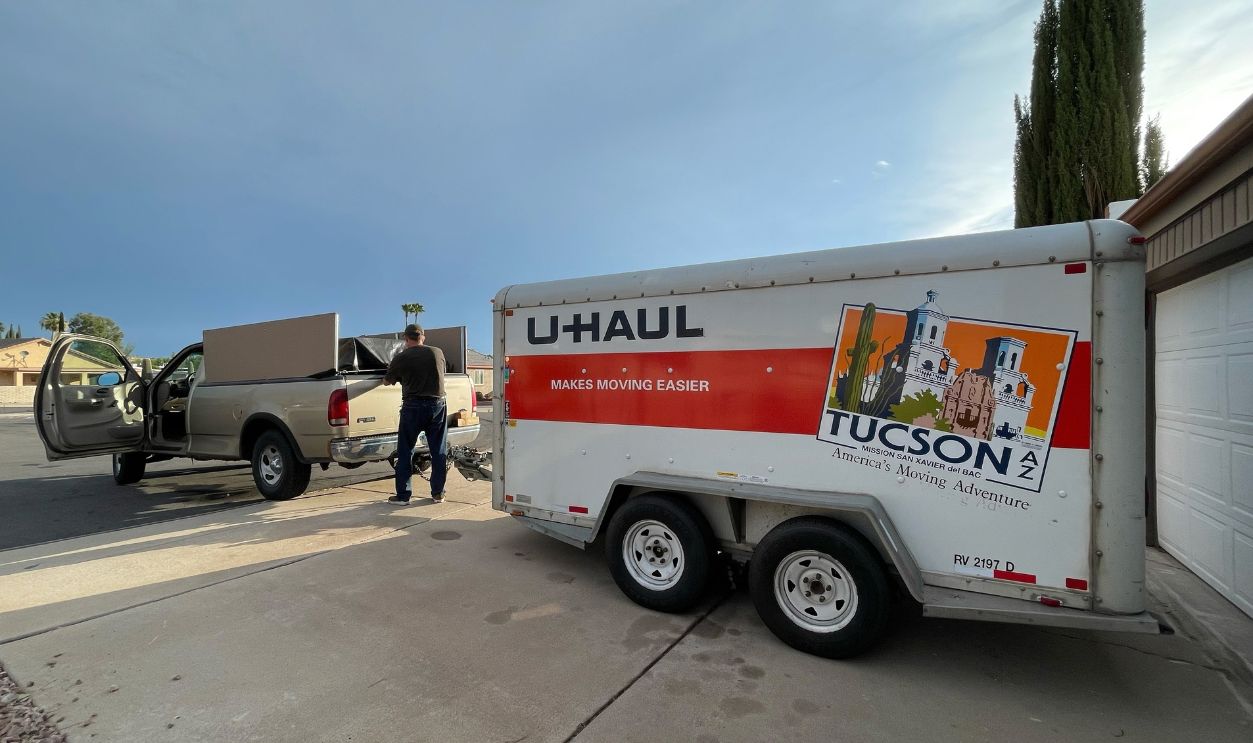 Tucson Arizona USA. July 24 2022. Man hitches truck and U Haul trailer getting ready to move.