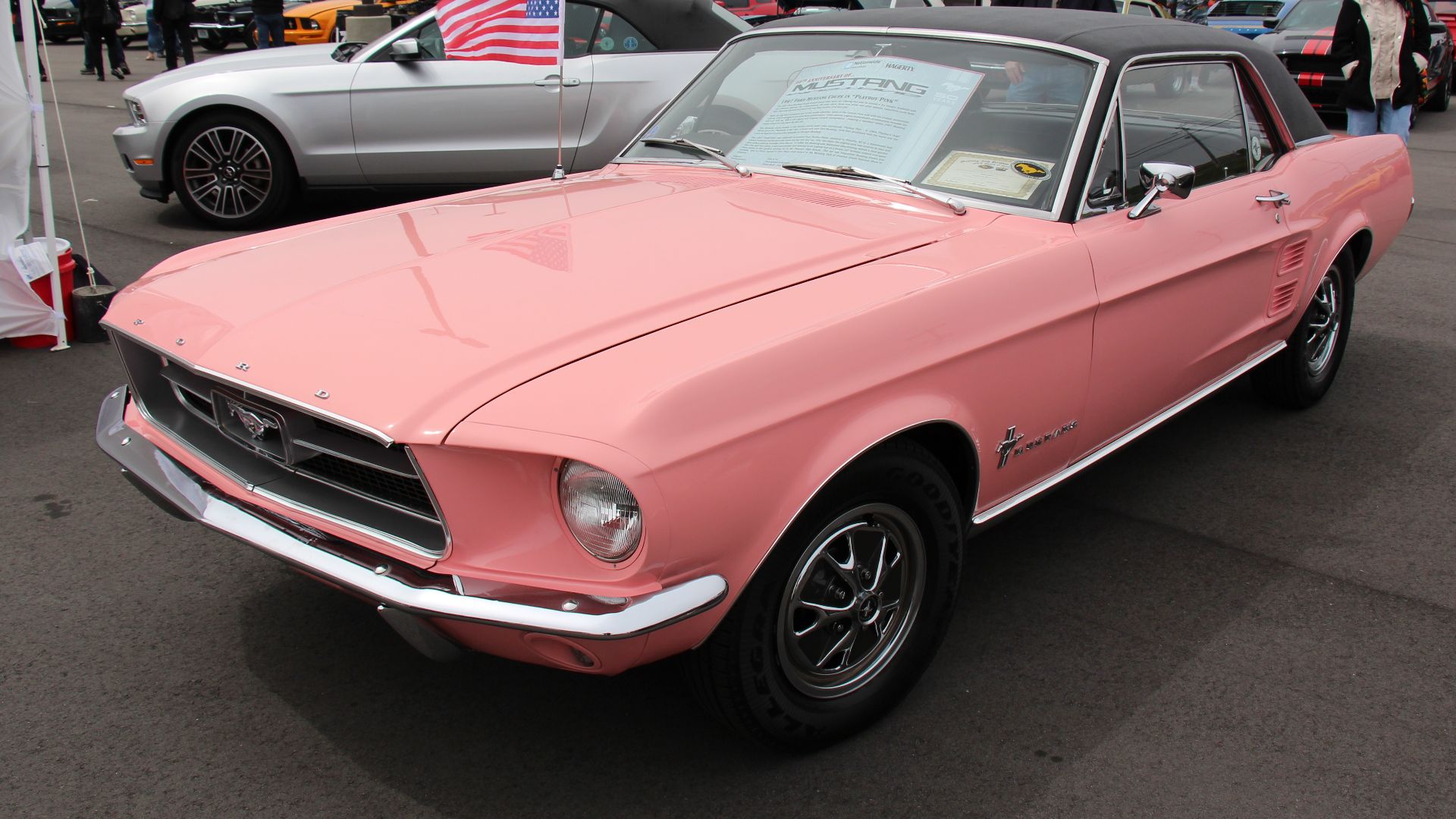 Playboy Pink. 
By 1967 Fords pony car gained some serious competition from the other manufacturers, so the new look was more muscular, the engine bay was larger to fit Fords 320hp 390 big block engine.
For 1967 the grille opening was larger and the bars t