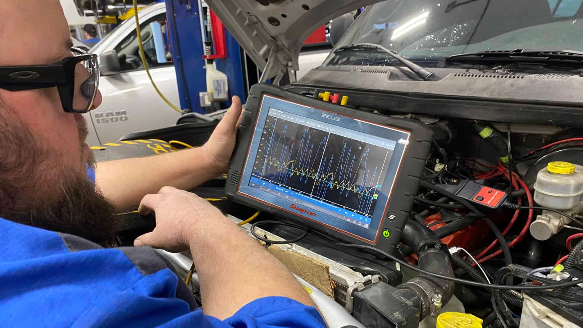 A man is diagnosing a electronic vehicle system