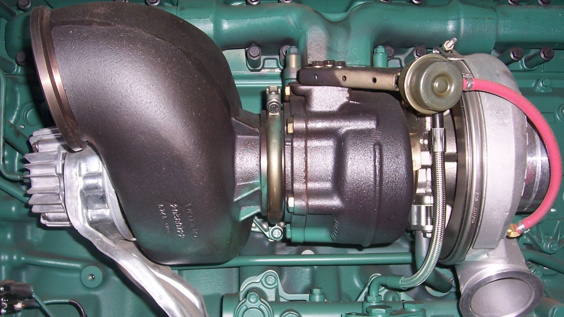 Close up of a turbocharger and an exhaust brake assembly on a truck engine