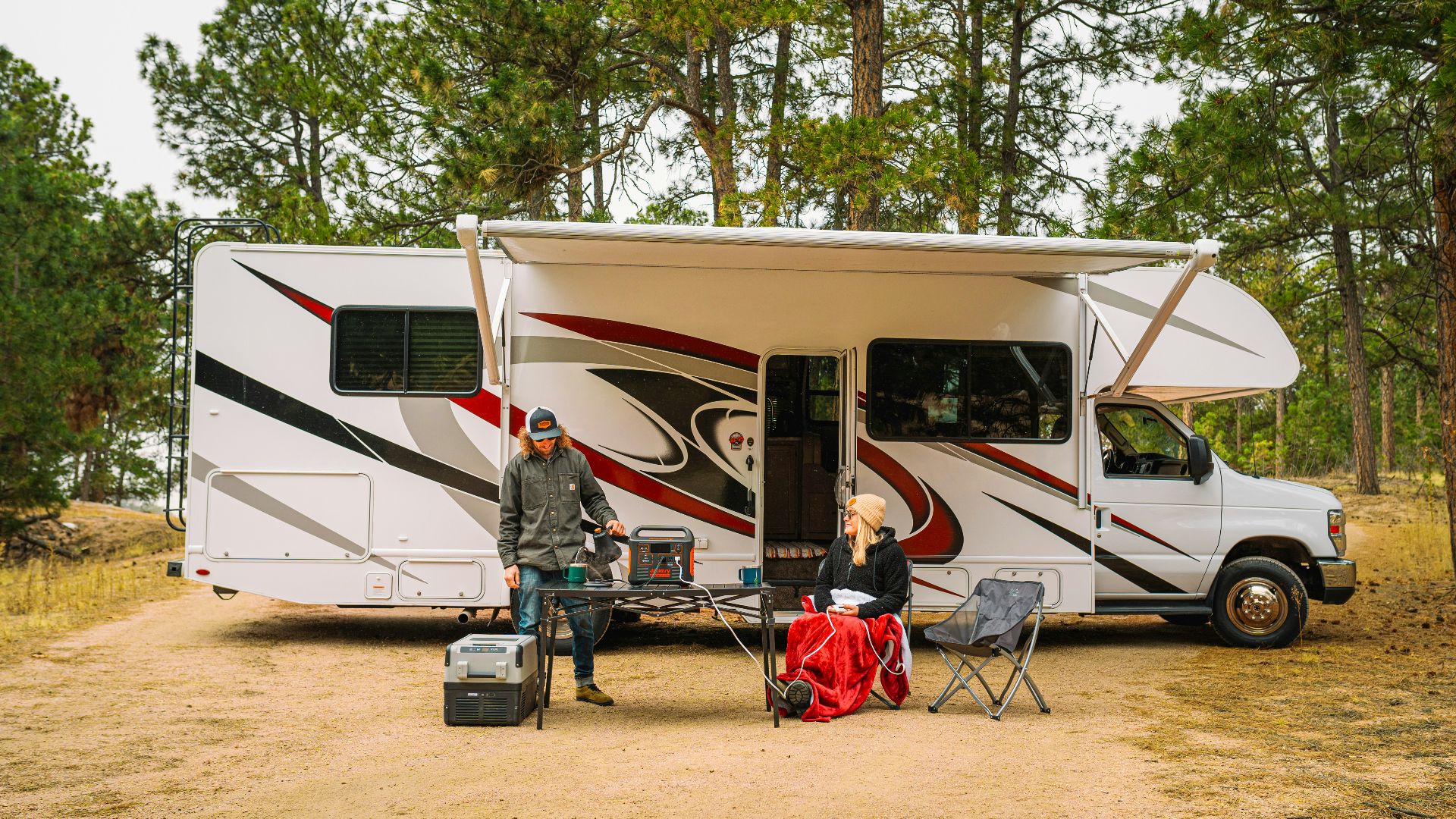 a group of people outside of a camper