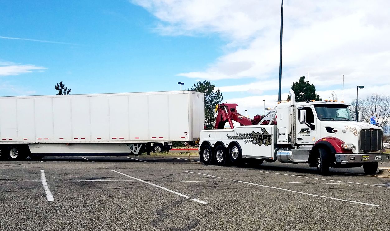 AURORA, COLORADO - APRIL 15, 2019: Tow Truck Is Pulling Away An Abandoned Trailer