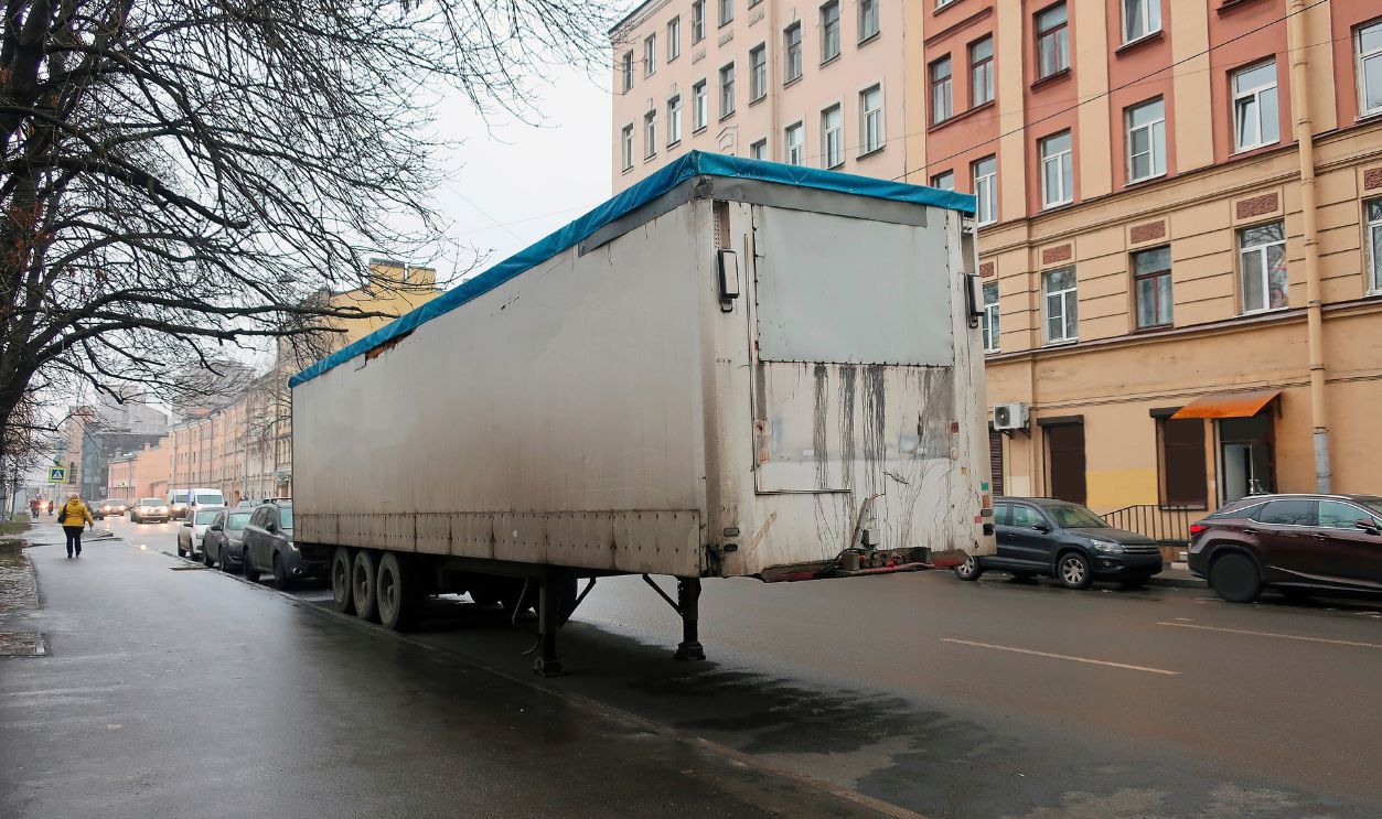 A large white freight van parked on the side of the road