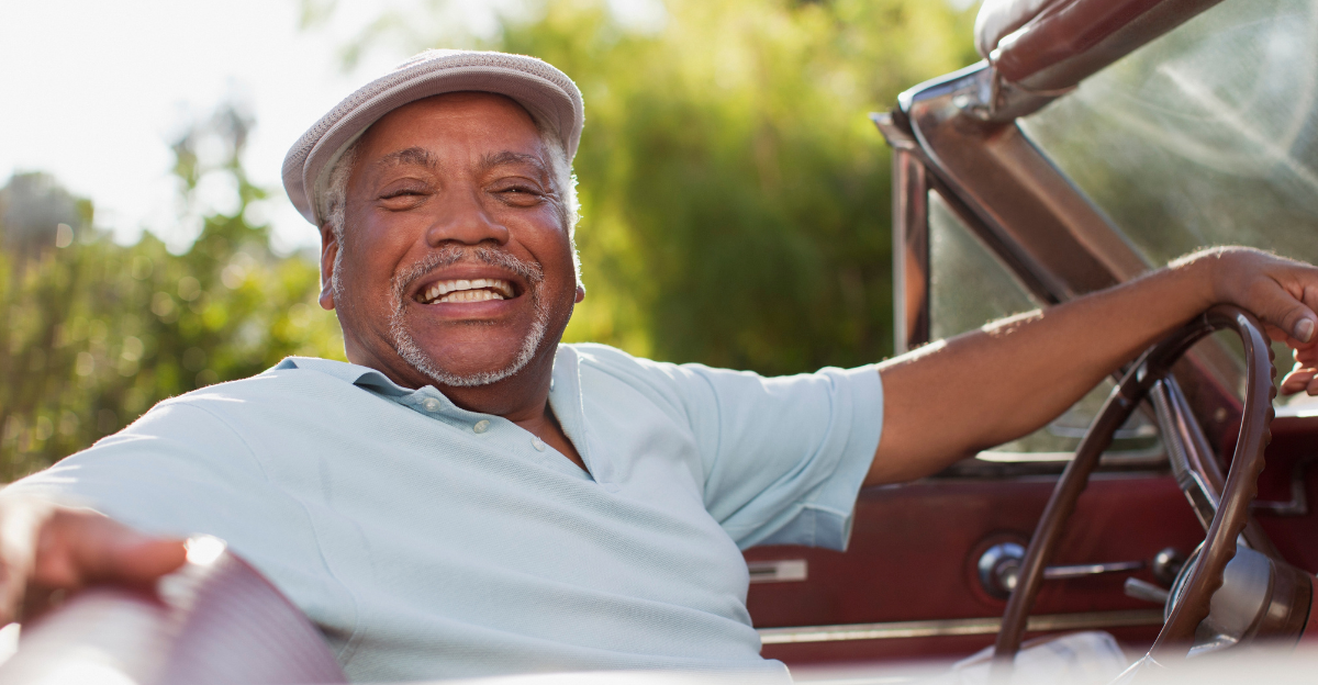 Smiling older man driving convertible