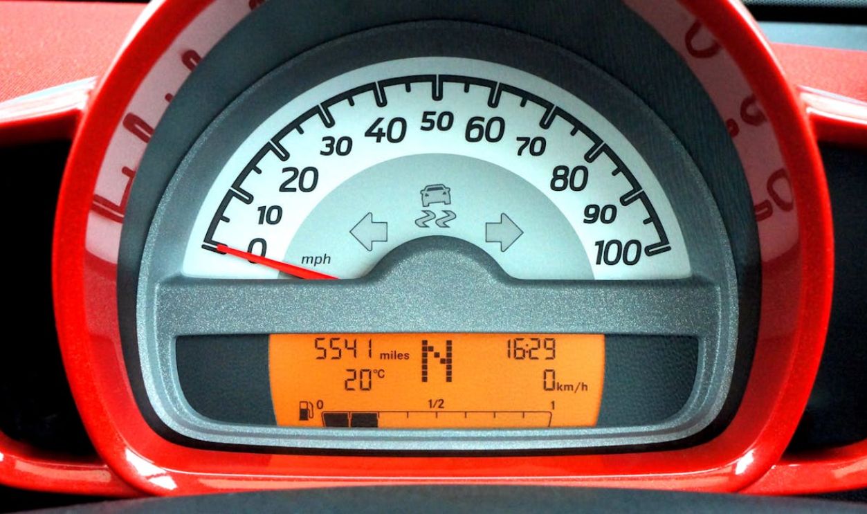 Red and Black Car Speedometer at Neutral