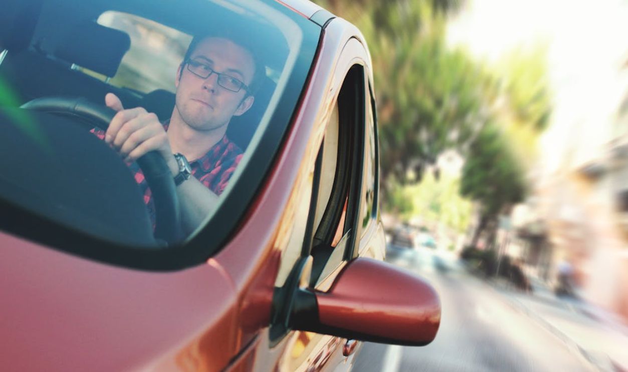 Man Driving the Red Vehicle
