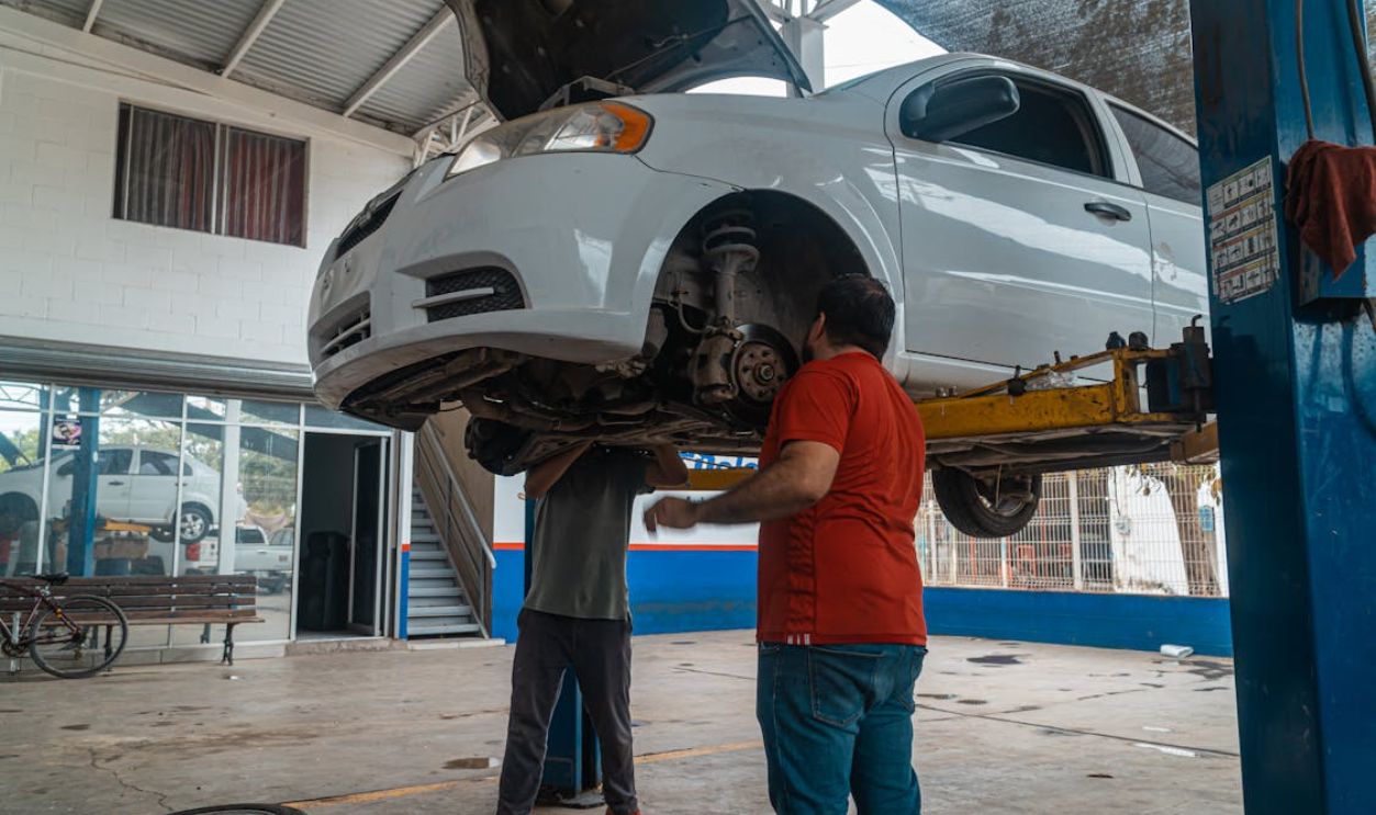 A Man Checking the White Car