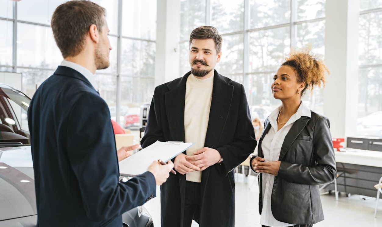 A Couple Talking to a Car Dealer