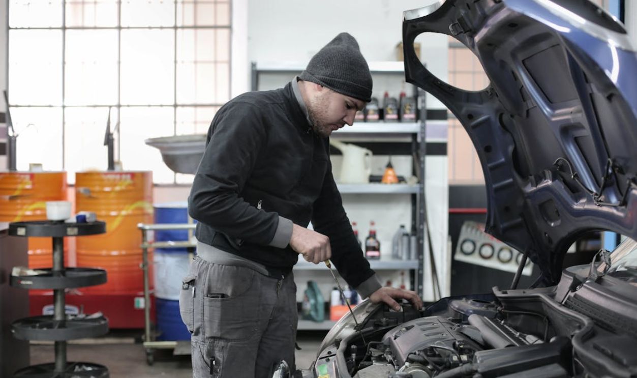 Photo of Man Inspecting Car Engine