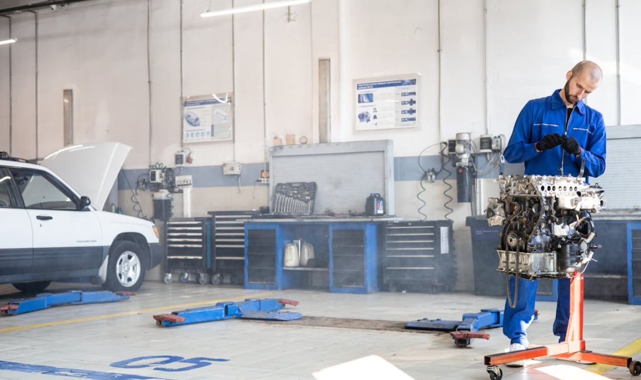 A Mechanic Working on an Engine in an Auto Repair Shop