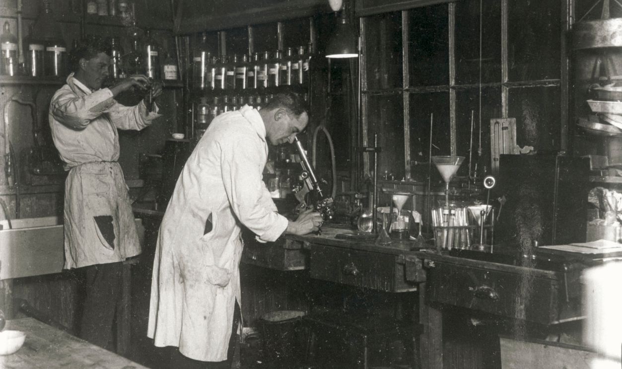 Two scientists at work in a laboratory, c 1930s. UNITED KINGDOM - FEBRUARY 23: Two scientists at work in a laboratory, c 1930s.