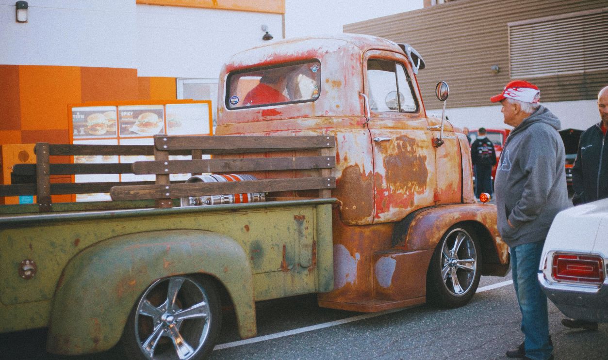 Elderly Man Looking at Truck