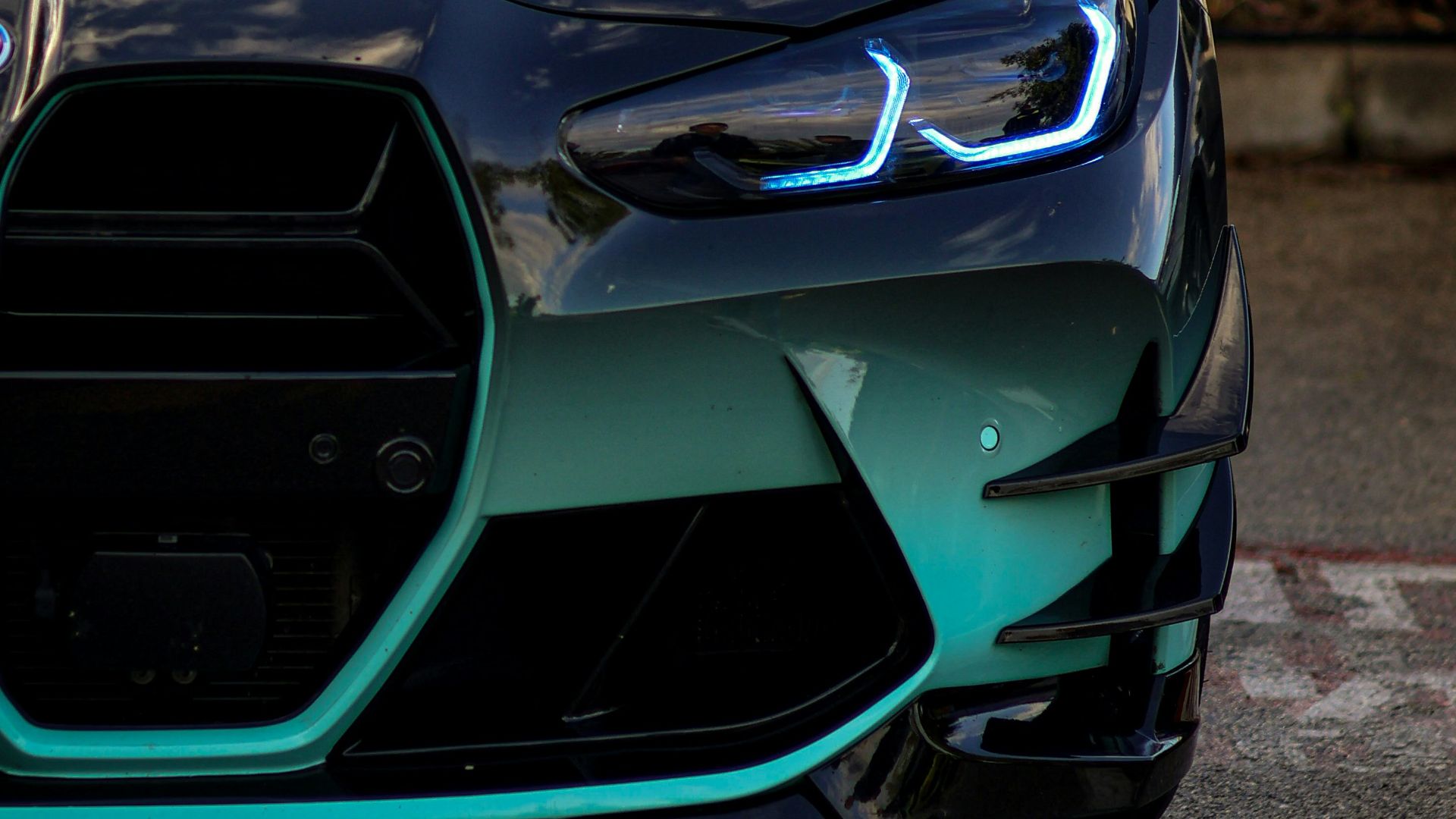 A blue and black sports car parked in a parking lot