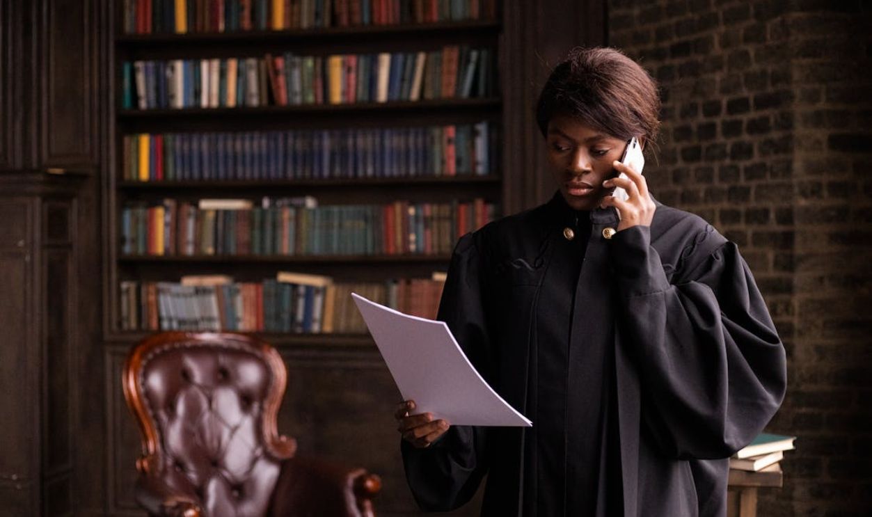A Judge Reading a Document while Having a Phone Call