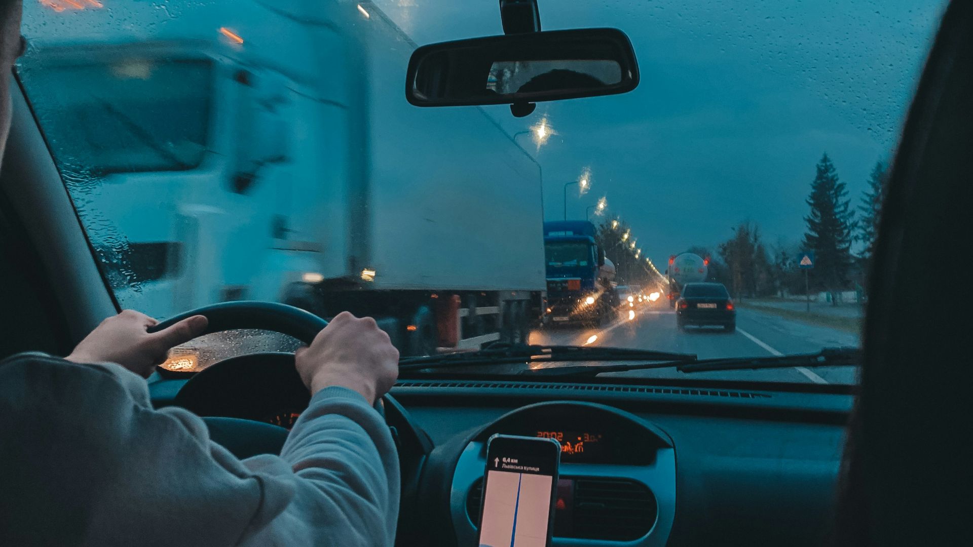 person in gray long sleeve shirt driving car