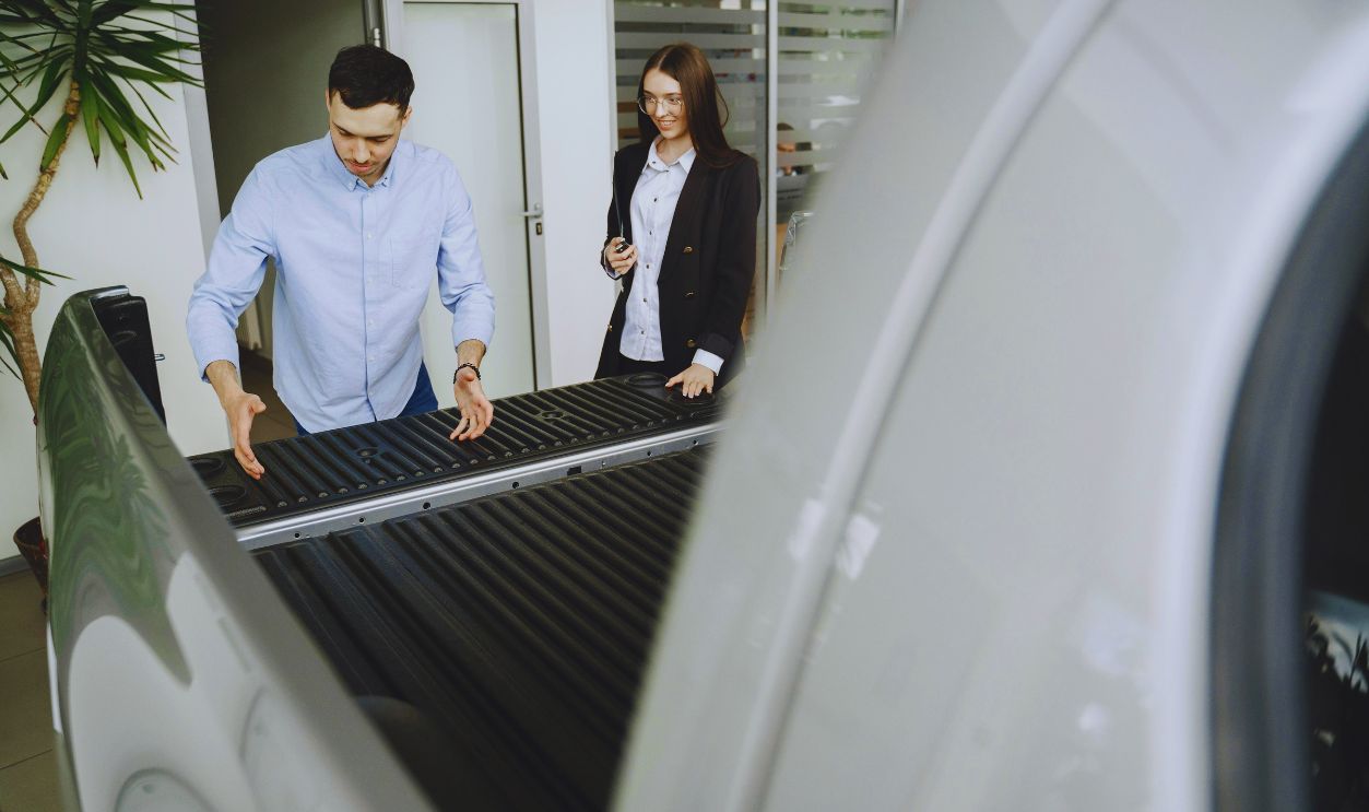 Man Looking at Pick-up Truck in Car Salon