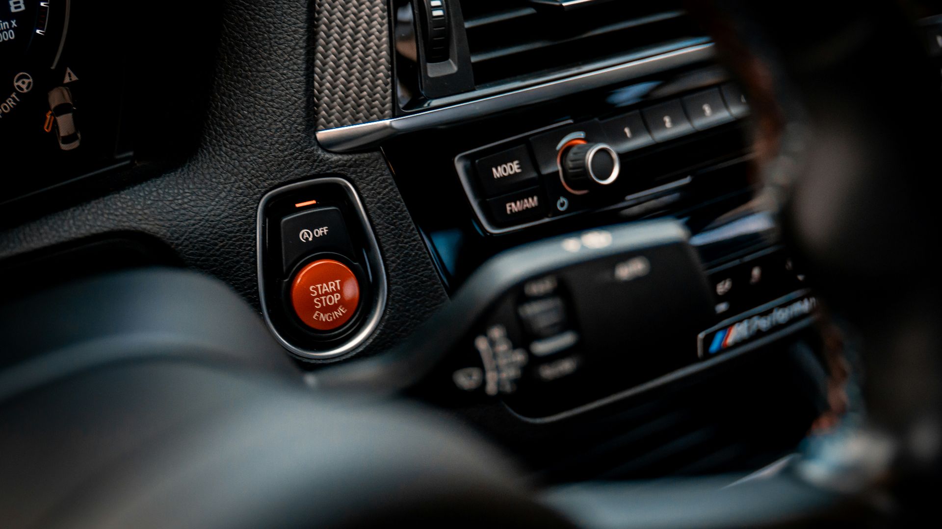 a close up of a car dashboard with a steering wheel