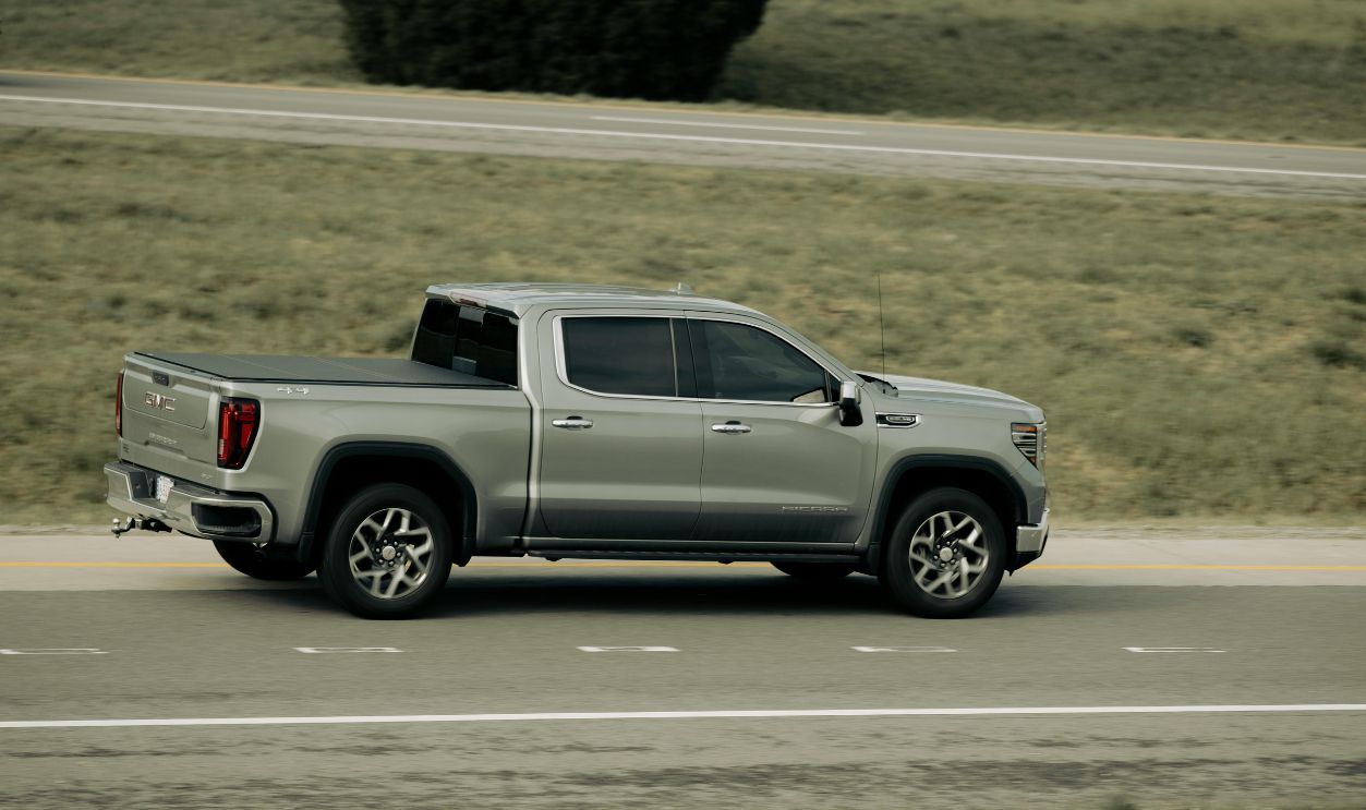 Silver pickup truck driving on open highway