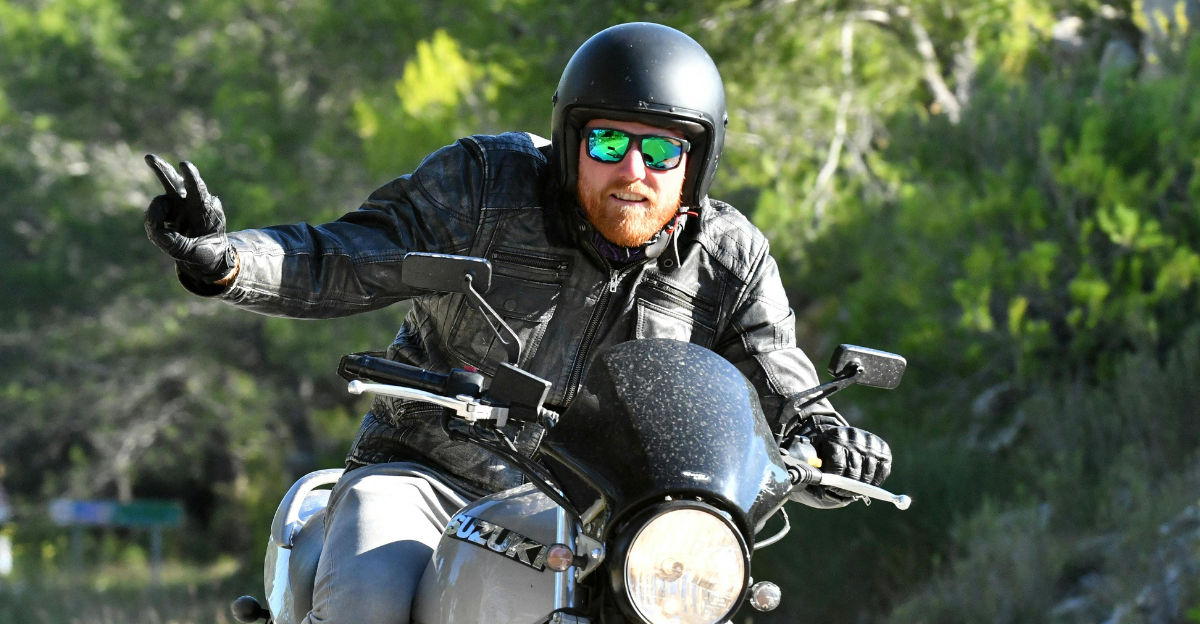man-riding-a-motorcycle-doing-a-peace-sign